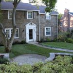 green grass, landscaped yard, house on a hill